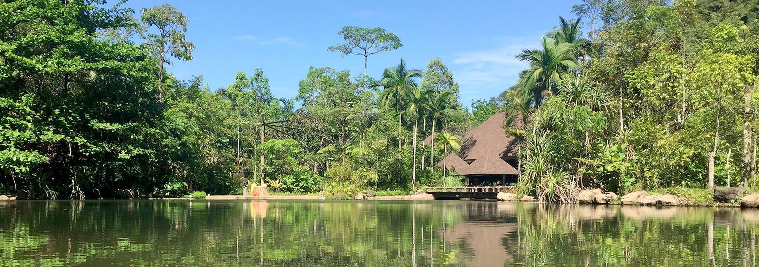 A house at the side of a tropical lake